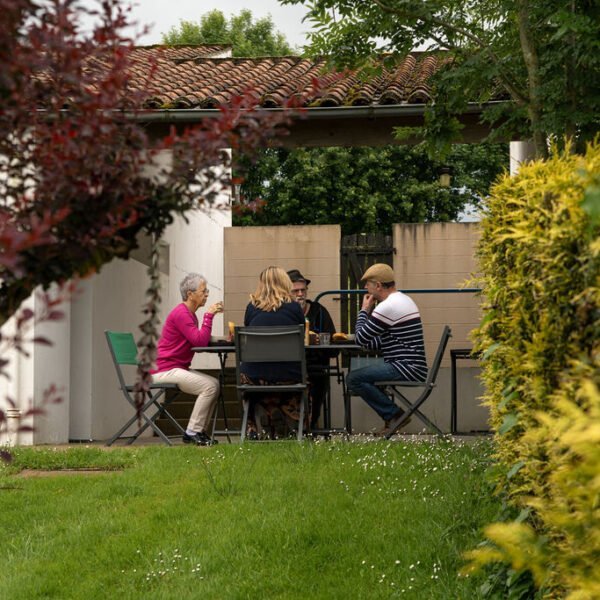 Personnes sur la terrasse de leur logement aux Gites Etang et Village près de Niort et des Marais Poitevins dans les Deux Sèvres en Nouvelle Aquitaine