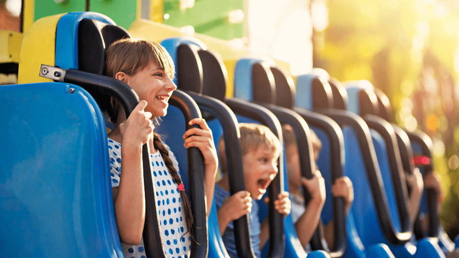 enfants dans l'attraction à sensations fortes d'un parc de loisirs où les chiens sont acceptés