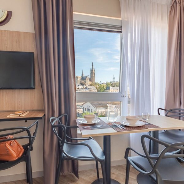 Espace repas avec vue sur la ville depuis un appartement d'Appart'City Classic Arlon Porte du Luxembourg en Belgique