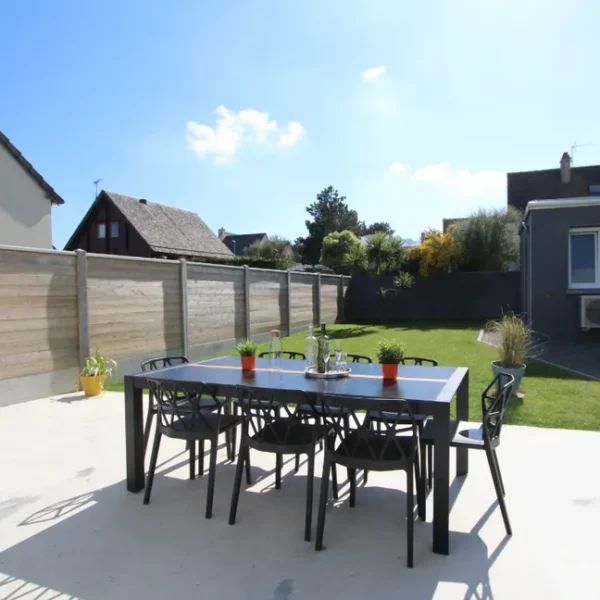 La table sur la terrasse et le jardin clos du Gîte L'abri côtier à Saint-Jean-de-la-rivière dans la Manche en Normandie