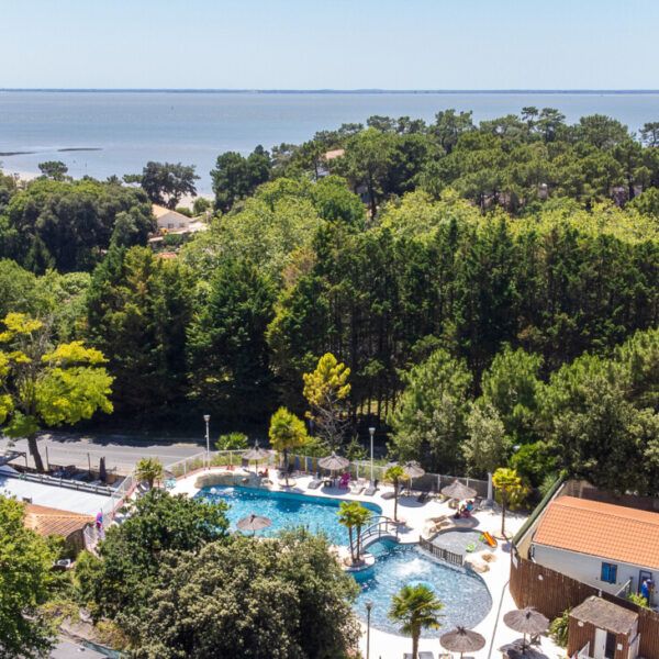 Swimming pool and sea view at Les Loges campsite near Royan in Charente Maritime in New Aquitaine