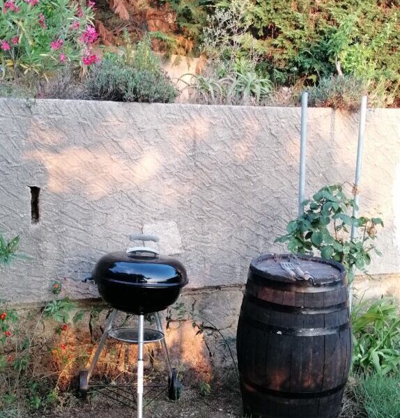 Barbecue in the enclosed garden of a cottage in Corsica