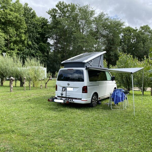 Motorhome on a shaded pitch at Camping Le Marais Sauvage in Vendée in the heart of the Poitevin marshes near Niort in Pays de Loire