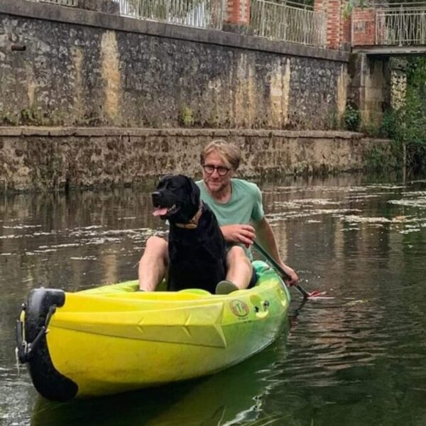 Vacancier et son chien sur l'un des canoés de la base Parcoul Canoe en Dordogne dans le Périgord en Nouvelle Aquitaine