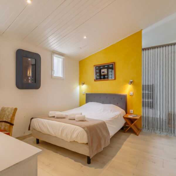 Chambre double jaune avec un bureau de la Villas Les Bains de Mer en Vendée au Pays de La Loire à La Barre-de-Monts